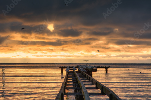 A beautiful golden sunset over an old boardwalk. Photo from Hallevik, Blekinge county, Sweden