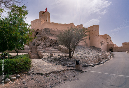 Walls of medieval arabian fortress in Nakhal, Oman. Hot day with haze in the sky. Old arabian castle. photo