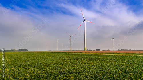 Wind turbines in flemish countryside under blue sky with white clouds, Diest, Flanders, Belgium