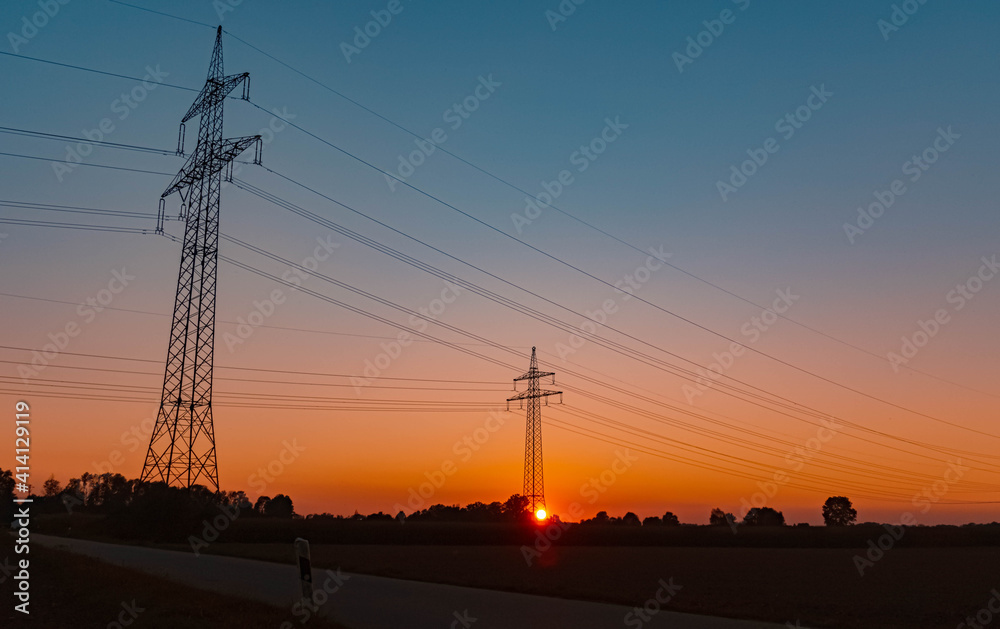 Beautiful summer sunset with high voltage overhead lines near Aholming, Bavaria, Germany