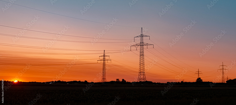 Beautiful summer sunset with high voltage overhead lines near Aholming, Bavaria, Germany