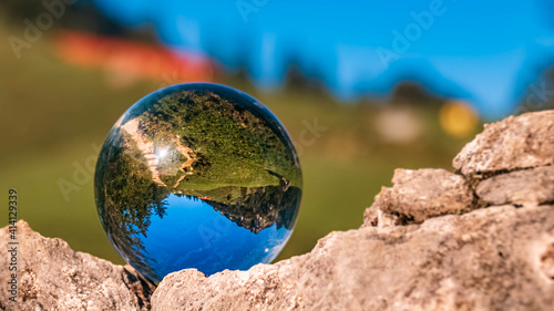 Crystal ball alpine summer landscape shot at the famous Hochfelln summit, Bergen, Bavaria, Germany