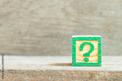 Color alphabet letter block in word question mark on wood background