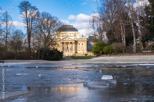 View over the frozen pond in the Warmer Damm park in Wiesbaden / Germany to the theater 