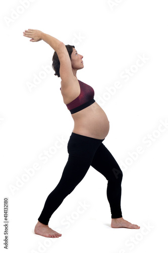 portrait of a pregnant woman exercising on white background © curto