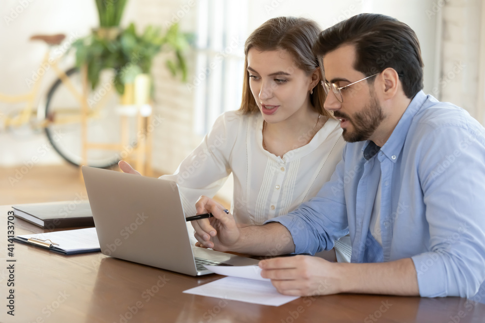 Smart focused young businesswoman discussing online project on computer with motivated male colleague. Confident manager helping female employee with modern software apps, collaboration concept. Smart focused young businesswoman discussing online project on computer with motivated male colleague. Confident manager helping female employee with modern software apps, collaboration concept.