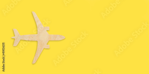 Wallpaper Mural Wooden airplane model on a yellow background, toy jet. Flight, vacation, flight search, ticket booking, travel insurance, dreams, tourism, open border. Minimal design banner, flat lay, copy space Torontodigital.ca