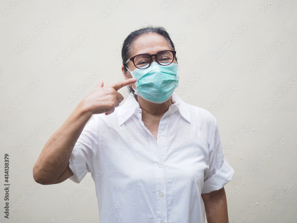 Old woman wearing medical mask