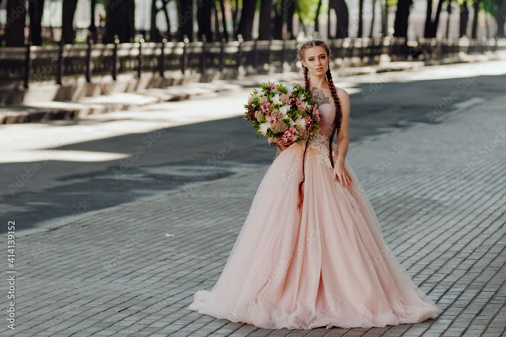 Portrait of a happy beautiful long-haired bride with two braids.