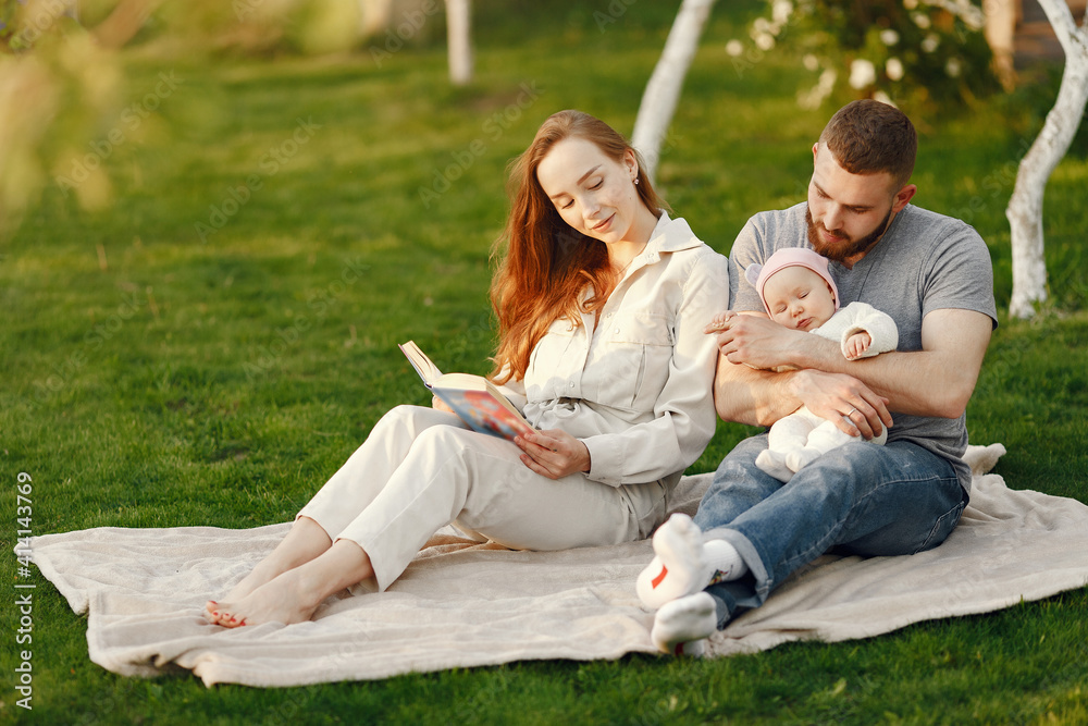 Parents with daughter. Family in a park. Newborn girl. Parents with daughter. Family in a park. Newborn girl.