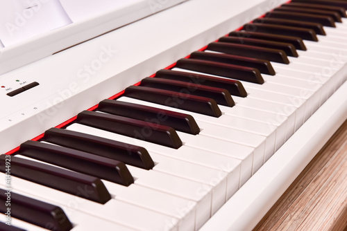 Close-up of an electronic piano keyboard. white digital piano for playing classical or modern music
