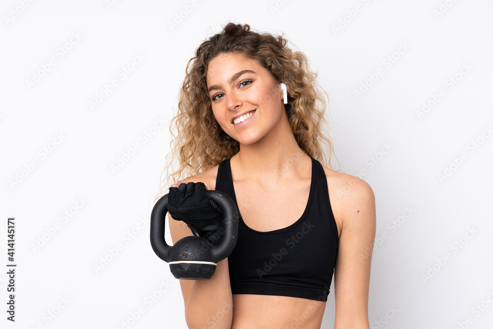 Young sport woman isolated on white background making weightlifting with kettlebell Young sport woman isolated on white background making weightlifting with kettlebell