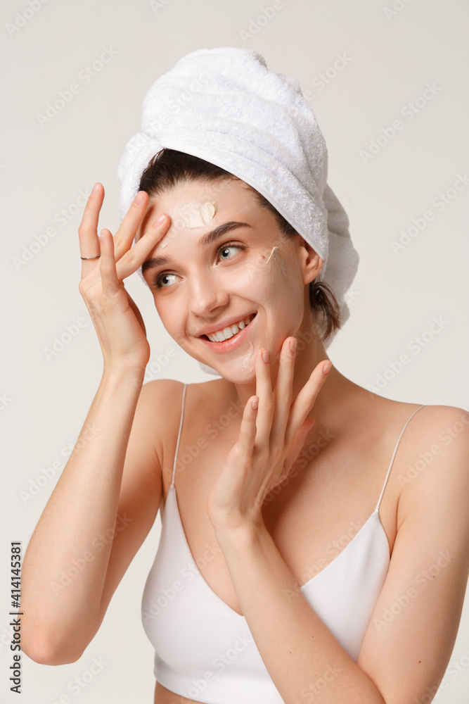 Beauty treatment - woman applying moisturing creame Beauty treatment - woman applying moisturing creame