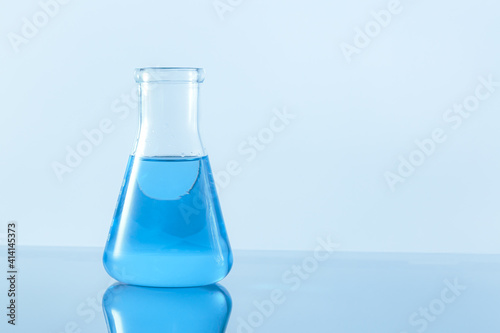 Test-tube with blue liquid isolated on white.