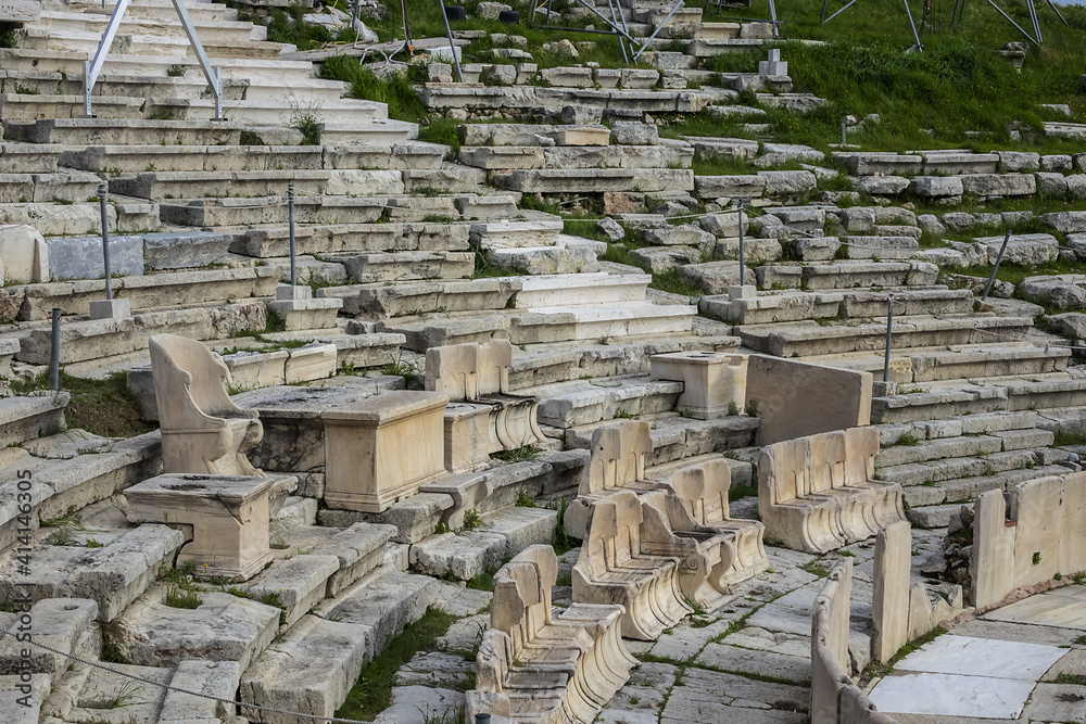 Fototapeta premium Picturesque view of Greek ruins of Theatre of Dionysos Eleuthereus - stone Roman Theater at the Acropolis hill. Theater dedicated to Dionysus, the god of plays and wine. Athens, Greece.
