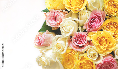 Roses in a bouquet of white  yellow  pink flowers on a light background
