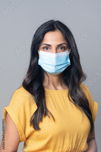 Beautiful Asian Indian woman wearing a protective mask.