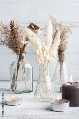 Fotografering Lit aroma candle and dry flowers