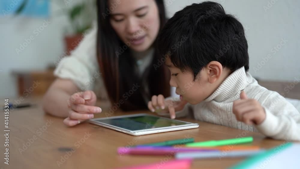 Asian teacher and little kid learning with tablet - Woman and child enjoy technology Asian teacher and little kid learning with tablet - Woman and child enjoy technology
