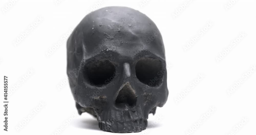 Dark skull rotating against white isolated background Dark skull rotating against white isolated background