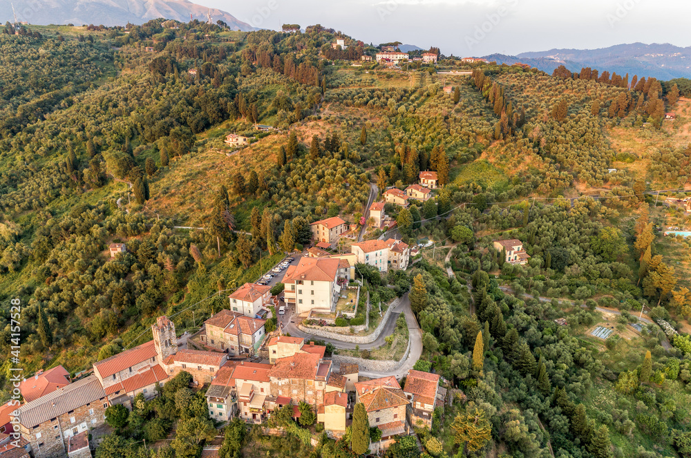 Aerial view of the Tuscan village Mommio Castello, at the top of the hill of Versilia, province of Lucca, Italy