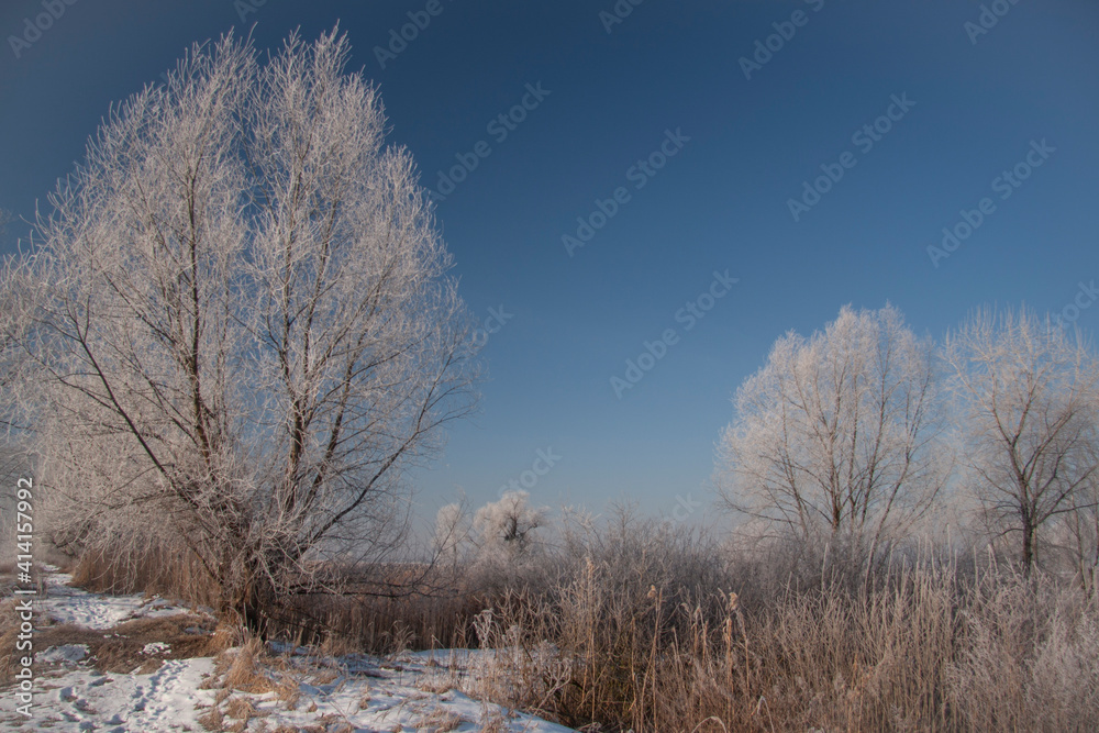 Spring landscape with a river covered with fog, melting snow on the river bank, trees Spring landscape with a river covered with fog, melting snow on the river bank, trees