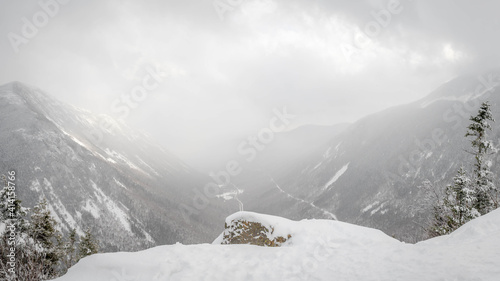 A snow squall passes through Crawford Notch in the NH White Mountains