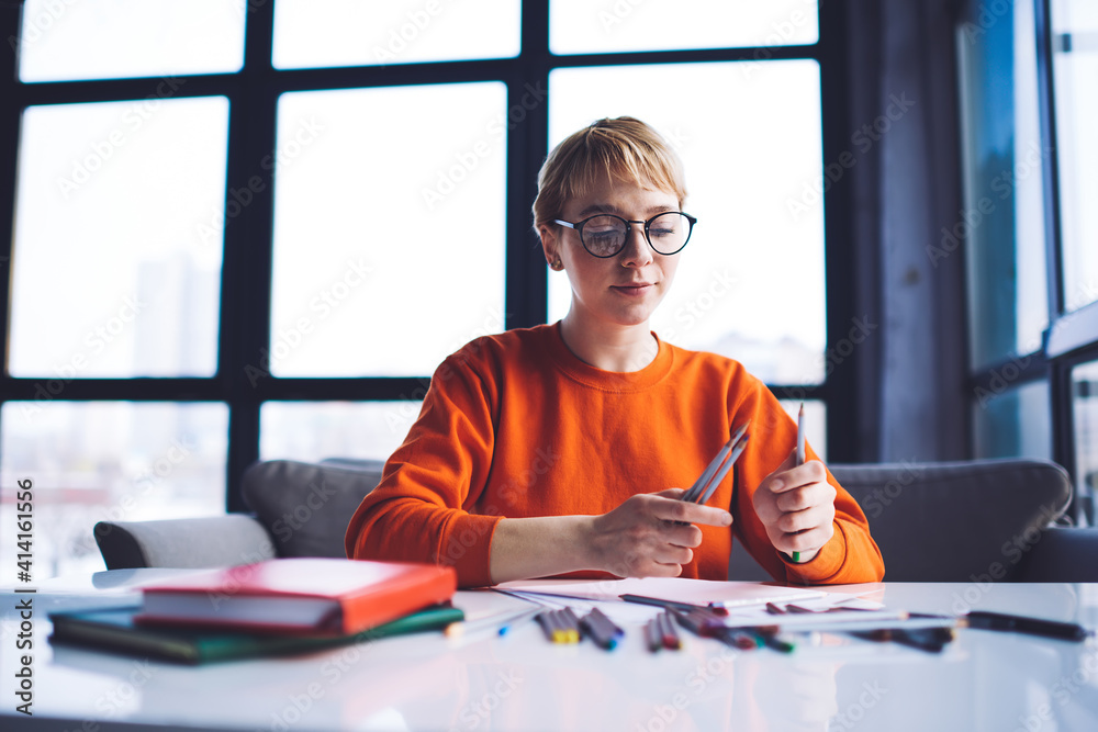 Glad woman with pencils in modern workspace Glad woman with pencils in modern workspace