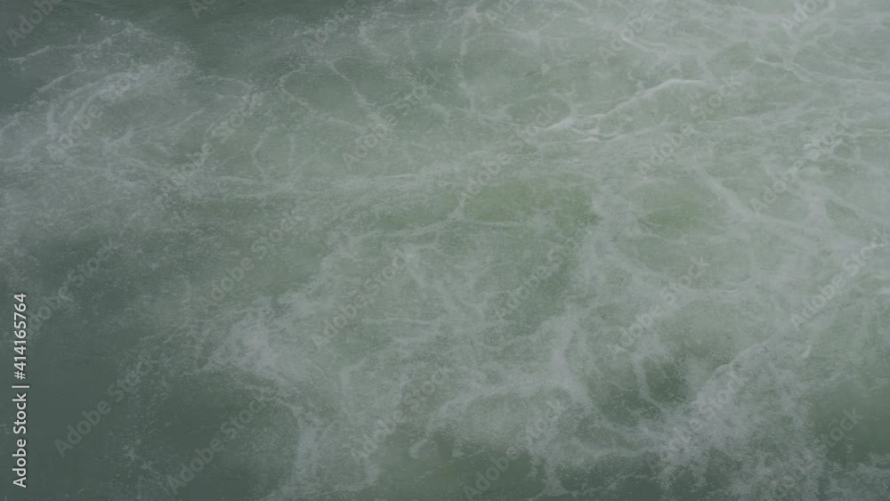 Foam waves on water surface. Stream of Sochi river flowing from mountains through city. Sochi, Russia. Foam waves on water surface. Stream of Sochi river flowing from mountains through city. Sochi, Russia.