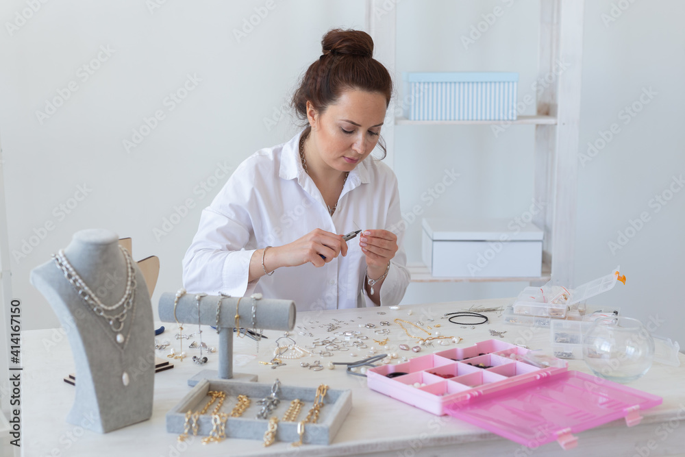 Professional jewelry designer making handmade jewelry in studio workshop. Fashion, creativity and handmade concept. Professional jewelry designer making handmade jewelry in studio workshop. Fashion, creativity and handmade concept.