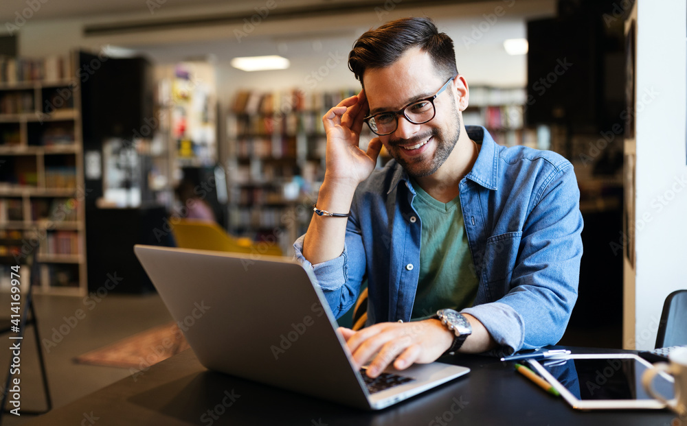 Happy man working on laptop. Technology people work study concept