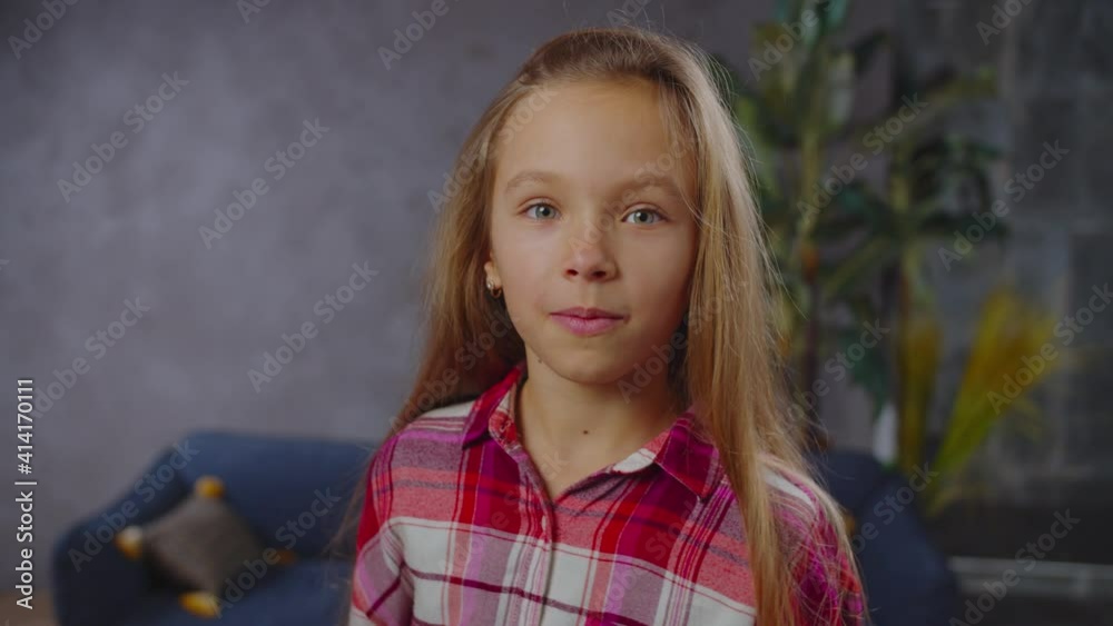 Closeup portrait of mischievous lovely preadolescent girl in casual clothes fooling around, having fun, making funny faces, grimaces and gestures, expressing carefree mood, excitement and joy indoor. Closeup portrait of mischievous lovely preadolescent girl in casual clothes fooling around, having fun, making funny faces, grimaces and gestures, expressing carefree mood, excitement and joy indoor.