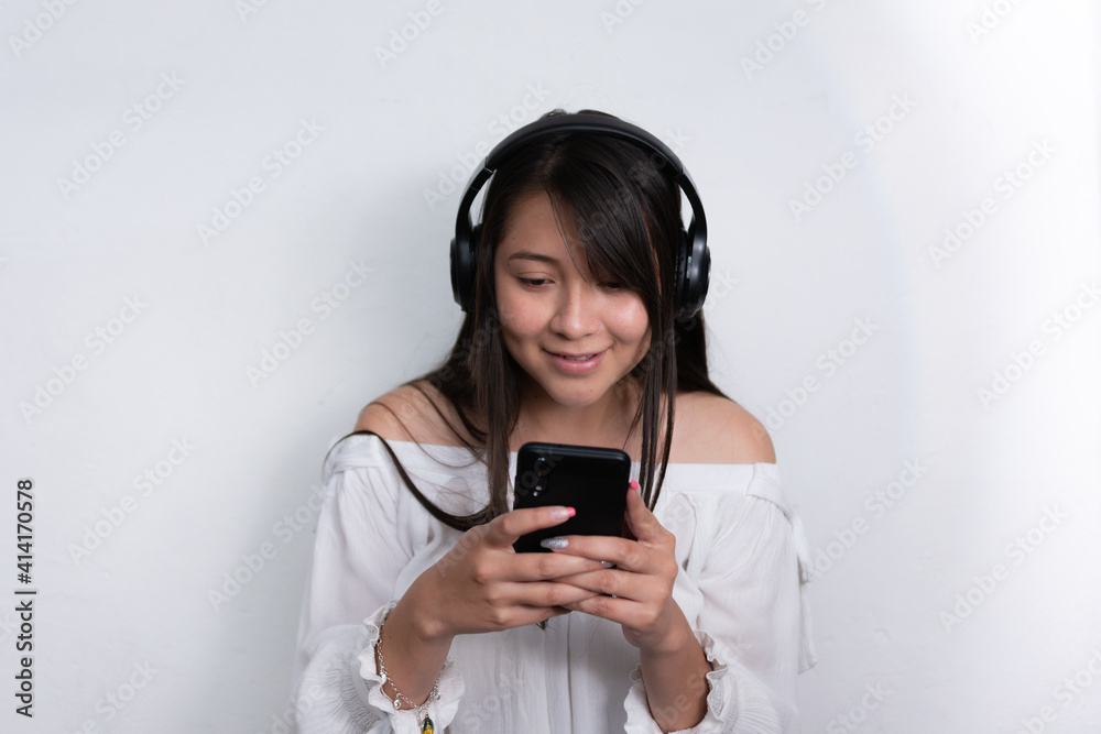 beautiful black Hispanic woman with long black hair using a cell phone on a white background beautiful black Hispanic woman with long black hair using a cell phone on a white background
