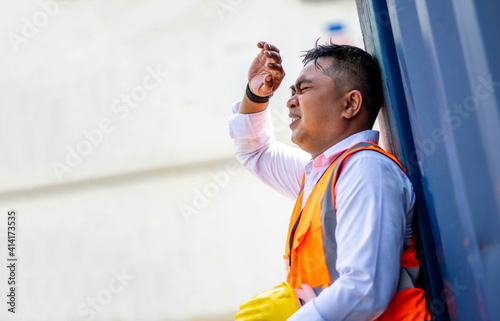 Factory worker man working in hot weather and he look tired from work.