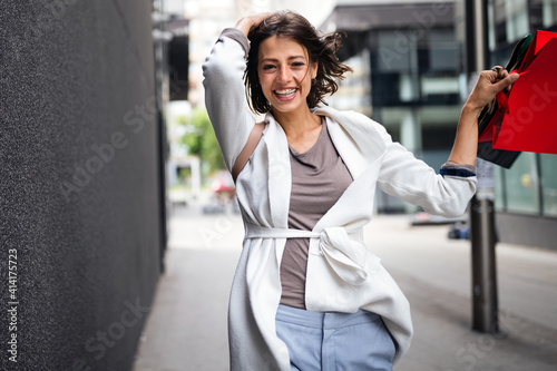 Very happy beautiful young woman in casual clothing with shopping bags © NDABCREATIVITY