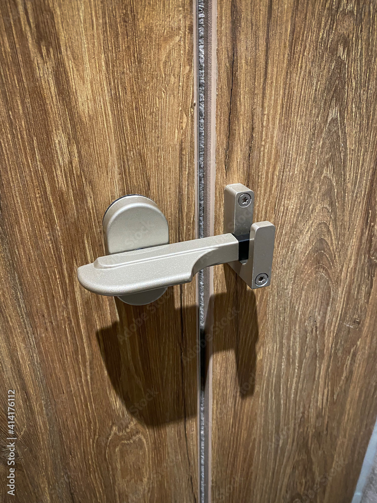 Toilet Door locking, stainless steel door knob, restroom. Stock Photo Adobe Stock
