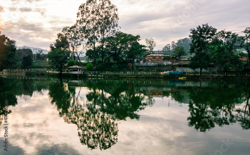 Reflections of trees in the waters of the Haflong lake in the North Cachar Hills of Assam in Northeast India.