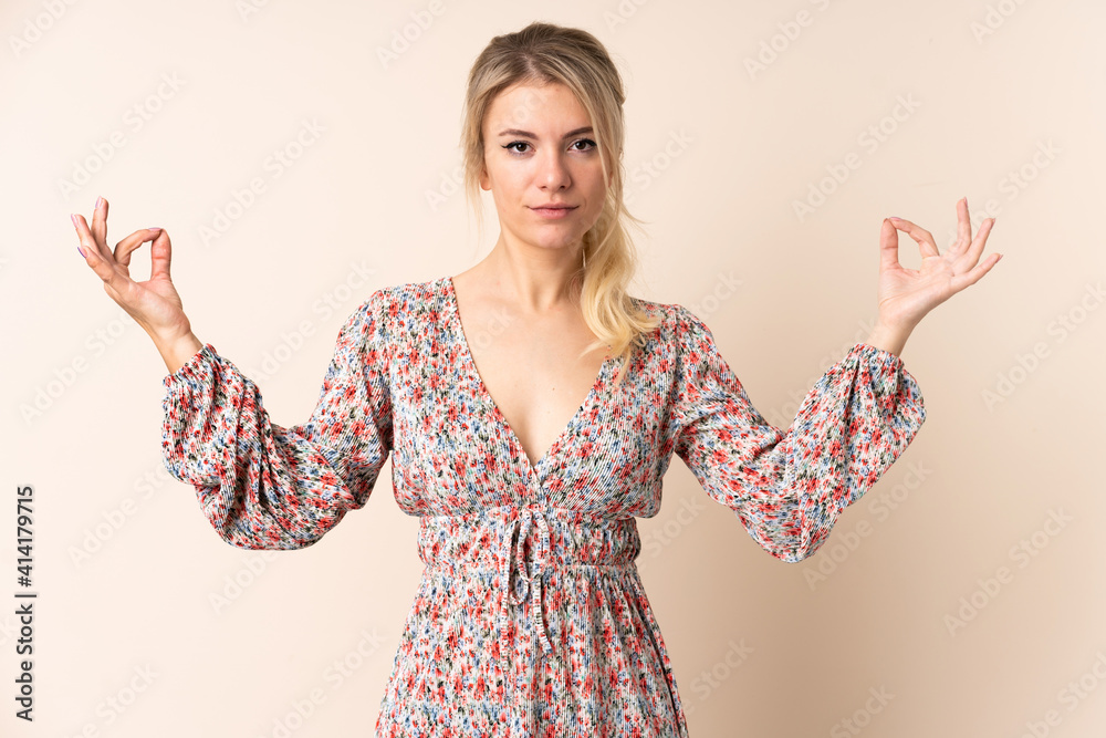 Blonde woman over isolated background in zen pose Blonde woman over isolated background in zen pose