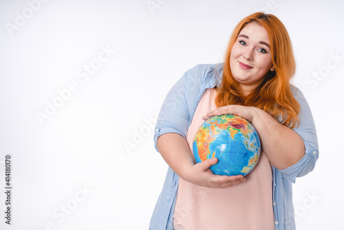 Young fat woman holding the globe with love and care , save the planet concept. Isolated over white background