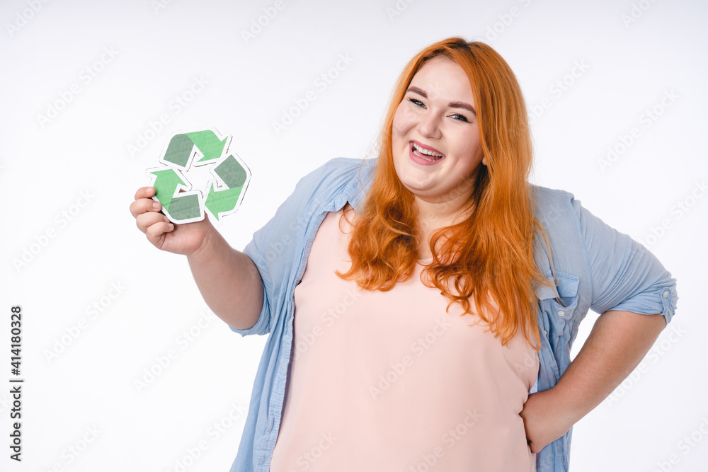 Smiling fat woman holding recycling sign isolated over white background Smiling fat woman holding recycling sign isolated over white background