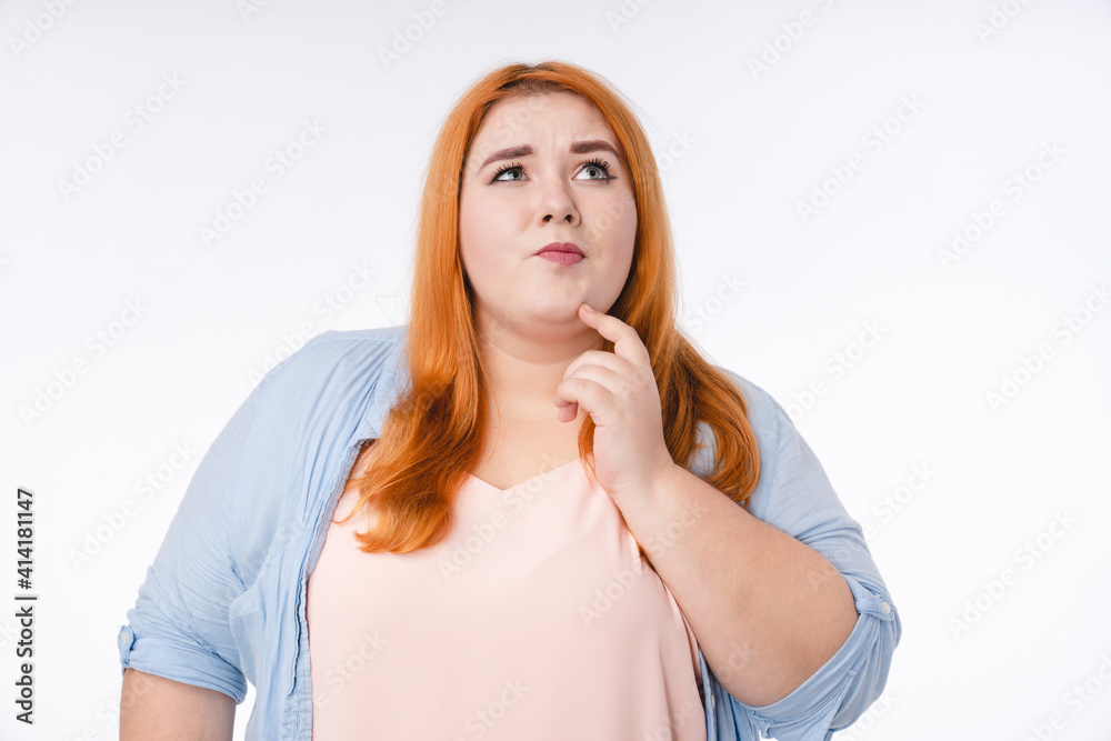 Pensive young plump woman thinking in casual attire isolated over white background Pensive young plump woman thinking in casual attire isolated over white background