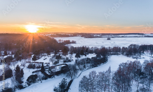 Drone shot above the Dam reservoir in Bautzen during sunset with frozen lake winter season ice snow