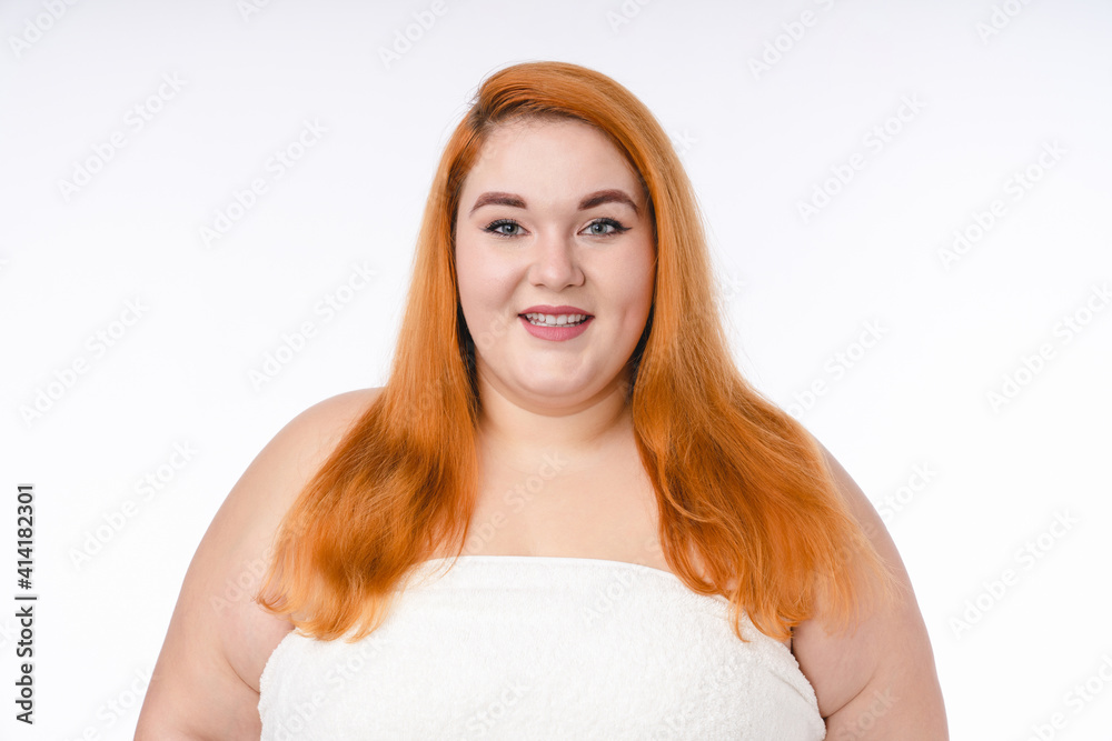 Plump red-haired woman with healthy skin isolated over white background Plump red-haired woman with healthy skin isolated over white background