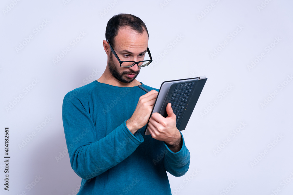 young office worker using ipad or tablet on white background with glasses with casual clothes. studio shot with copy space on white background young office worker using ipad or tablet on white background with glasses with casual clothes. studio shot with copy space on white background