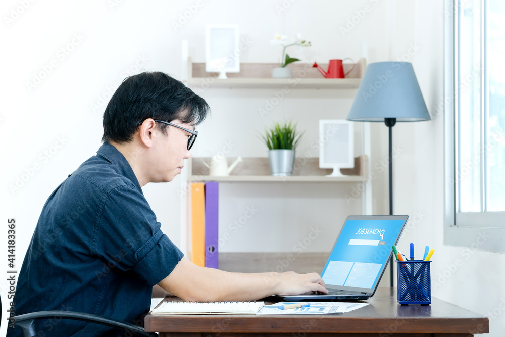 Man in business casual use laptop at desk to find new job. Company employee searching better job with Internet online Man in business casual use laptop at desk to find new job. Company employee searching better job with Internet online