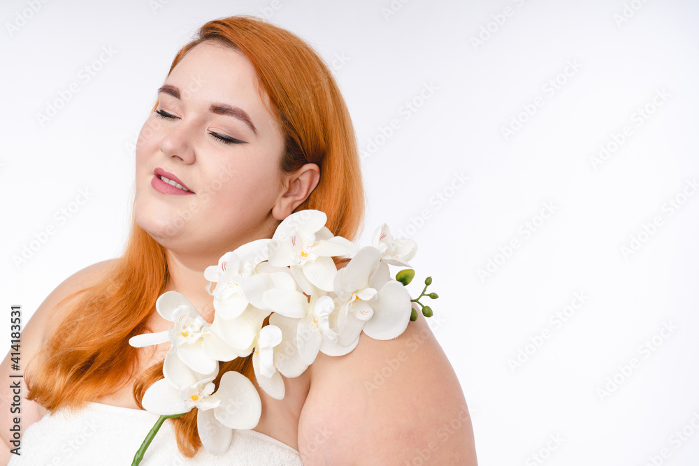 Charming fat redhead woman with flower isolated over white background Charming fat redhead woman with flower isolated over white background