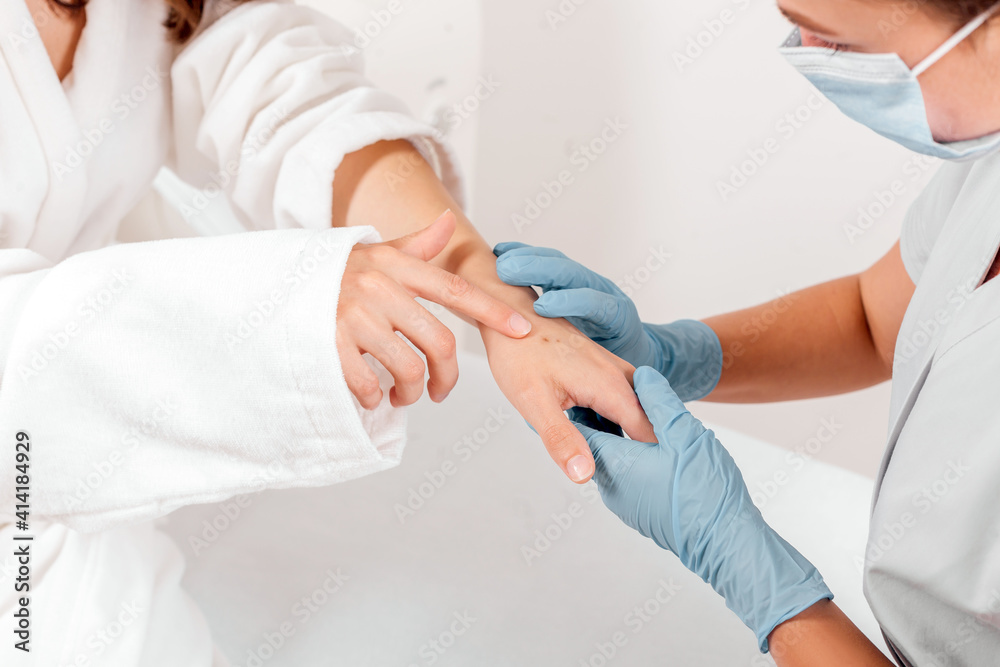 Woman show spots on her skin to dermatologist Woman show spots on her skin to dermatologist