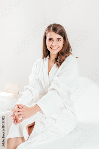 Young woman portrait making laser epilation in beauty center
