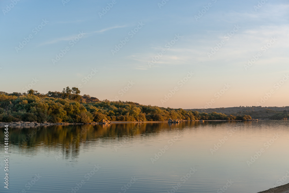 Landscape with lake reflection at sunset of Nisa Dam in Alentejo, Portugal Landscape with lake reflection at sunset of Nisa Dam in Alentejo, Portugal
