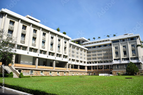 Ho Chi Minh City, Vietnam - Jan 4 2020: Backside view of the infamous Independence Palace in Saigon with an architecturally unique facade and palm trees on the roof